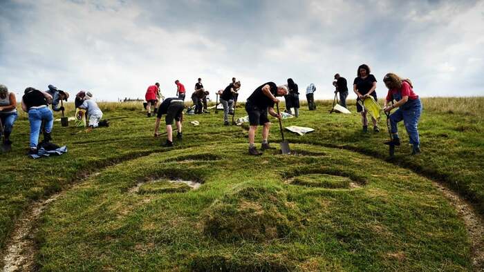 Voluntários renovam o giz da figura histórica. (Fonte: National Trust UK)