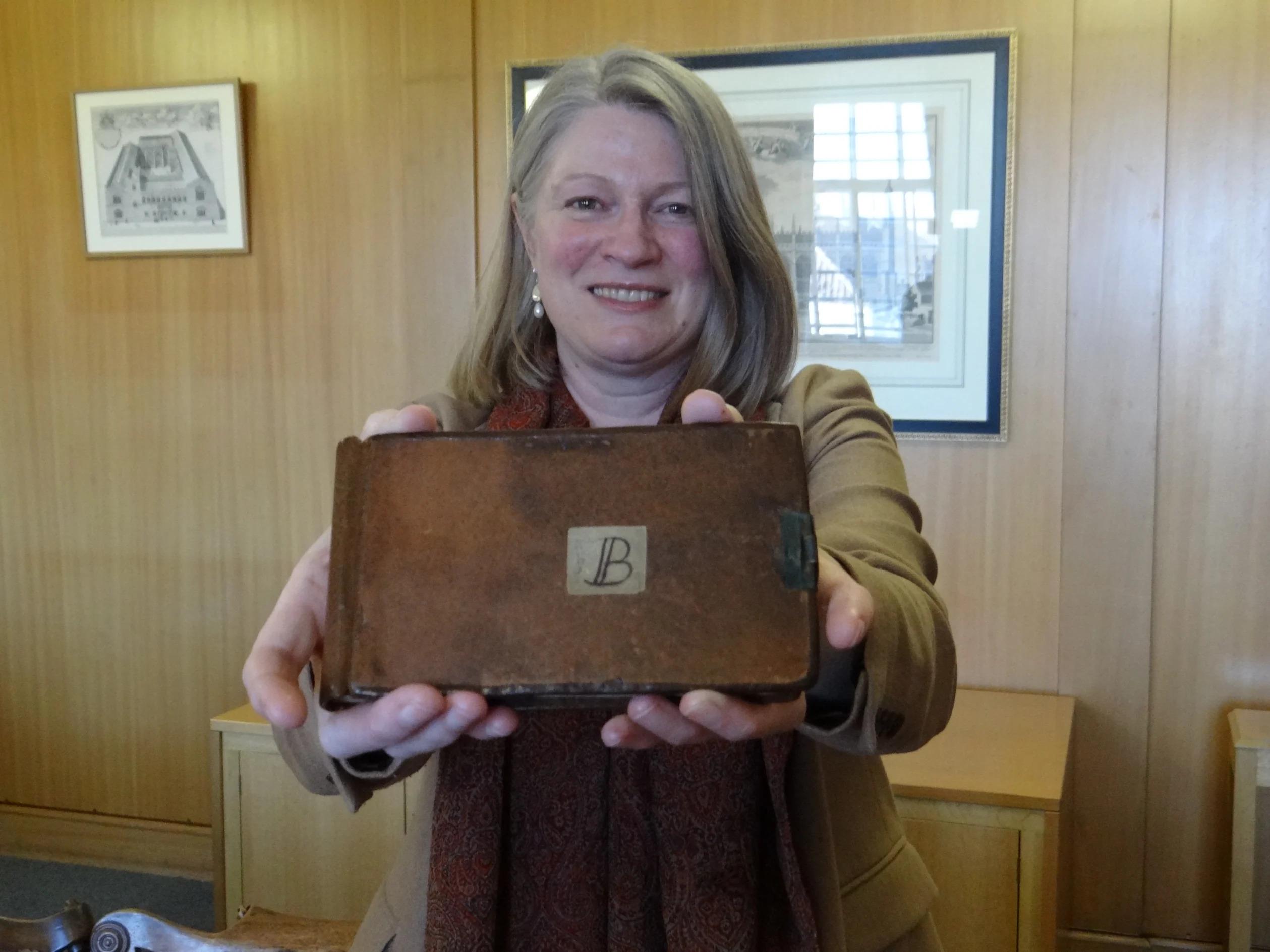 Jessica Gardner and one of the returned notebooks (Source: University of Cambridge/reproduction)