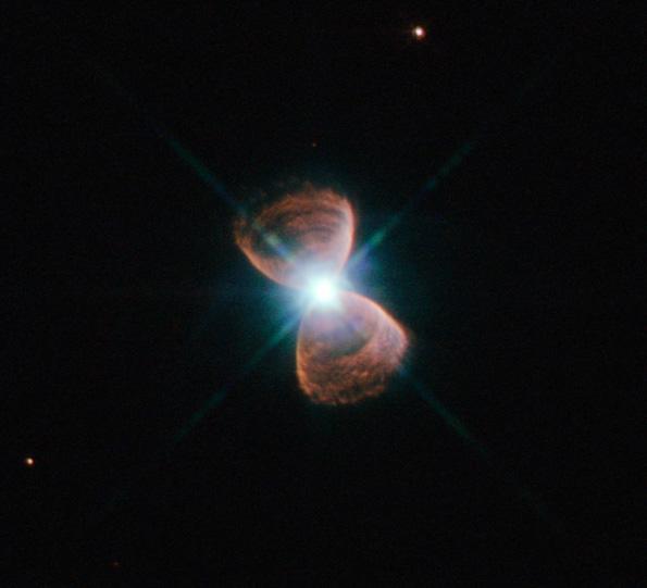 A bipolar planetary nebula has two bowls joined at the bottom;  an example of such a system is Hubble 12 (Source: Wikimedia Commons/NASA/ESA)