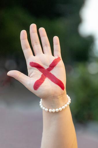 The red X on the hand is also a domestic violence distress call.