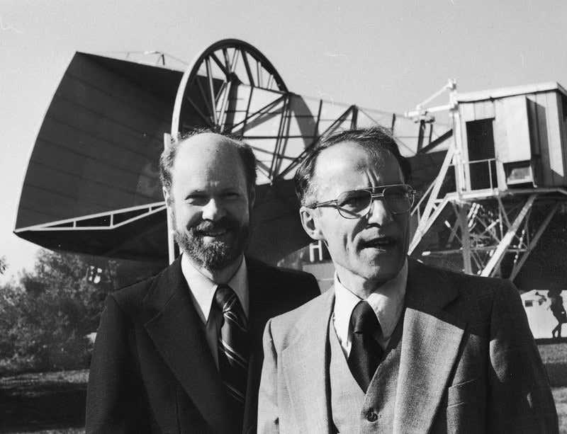 Robert Wilson and Arno Penzias in front of the antenna detecting the cosmic microwave background.